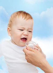 Image showing crying baby with dummy