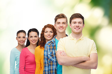 Image showing group of smiling teenagers over green background