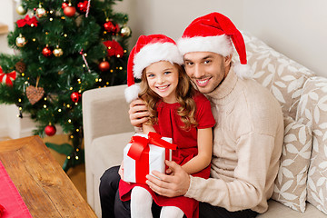 Image showing smiling father and daughter holding gift box