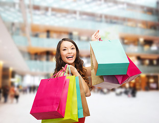 Image showing smiling woman with colorful shopping bags