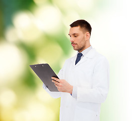 Image showing serious male doctor with clipboard