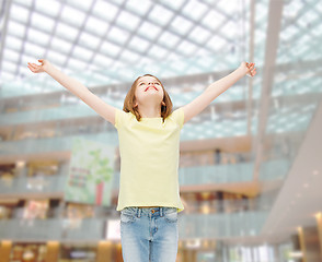 Image showing smiling teenage girl with raised hands