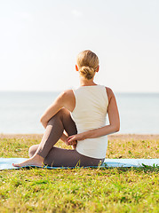 Image showing woman making yoga exercises outdoors