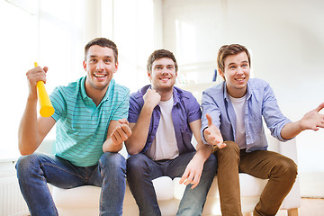 Image showing happy male friends with vuvuzela