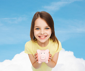 Image showing beautiful little girl with piggy bank