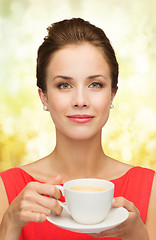 Image showing smiling woman in red dress with cup of coffee