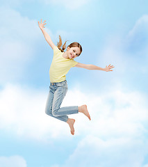 Image showing smiling little girl jumping