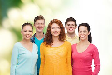 Image showing group of smiling teenagers over green background