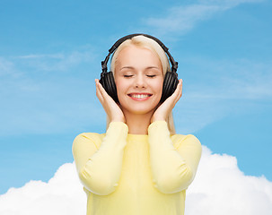 Image showing smiling young woman with headphones