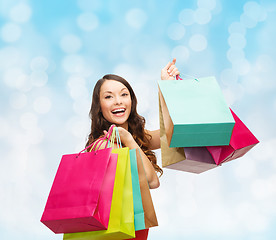 Image showing smiling woman with colorful shopping bags