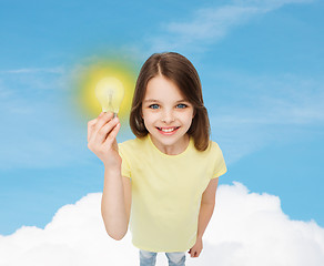 Image showing smiling little girl holding light bulb