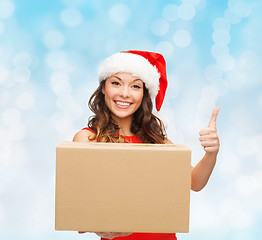 Image showing smiling woman in santa helper hat with parcel box