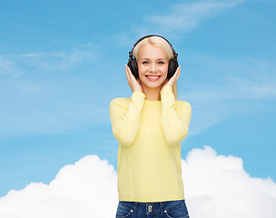 Image showing smiling young woman with headphones