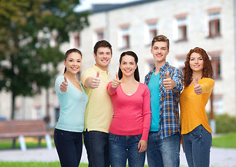 Image showing group of smiling teenagers over campus background