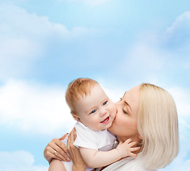 Image showing happy mother kissing smiling baby