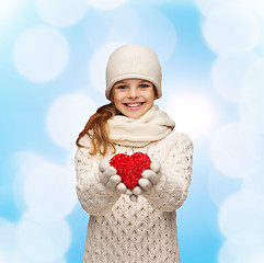 Image showing dreaming girl in winter clothes with red heart