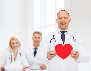 Image showing smiling male doctor with red heart and stethoscope