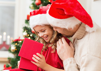 Image showing smiling father and daughter opening gift box