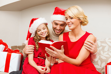 Image showing smiling family reading book