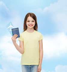 Image showing smiling little girl with ticket and passport