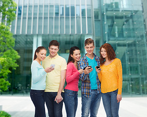 Image showing group of smiling teenagers with smartphones