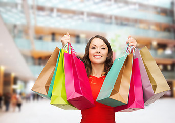 Image showing smiling woman with colorful shopping bags