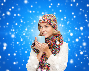 Image showing smiling young woman in winter clothes with cup