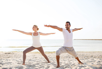 Image showing couple making yoga exercises outdoors