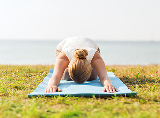 Image showing close up of woman making yoga exercises outdoors