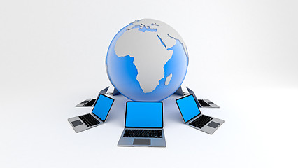 Image showing Laptops around globe. Global network concept.