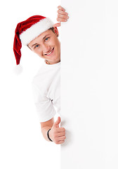 Image showing Young man in Santa hat