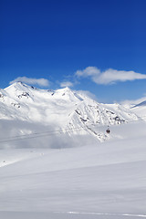 Image showing Winter snowy mountains and ski slope at nice day.