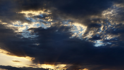 Image showing Dark sunrise sky with rays