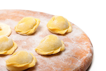 Image showing Raw ravioli on wooden cutting board