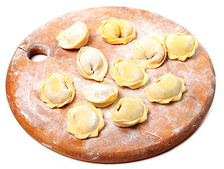 Image showing Raw homemade ravioli on wooden cutting board