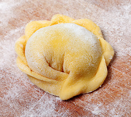 Image showing Raw ravioli on wooden cutting board