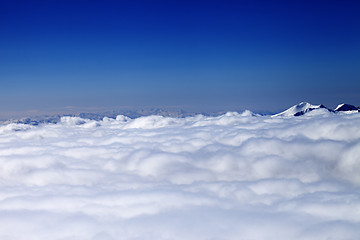 Image showing Mountains under clouds in sun winter day