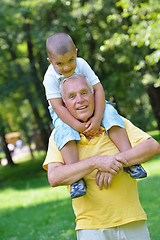 Image showing happy grandfather and child in park