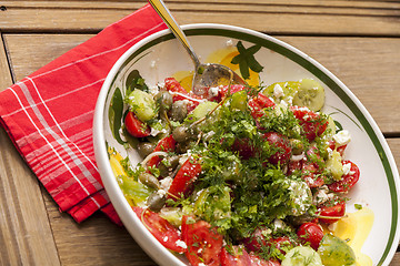 Image showing Bowl of Marinated Greek Salad with Red Napkin