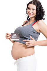 Image showing Pregnant woman displaying a prenatal ultrasound