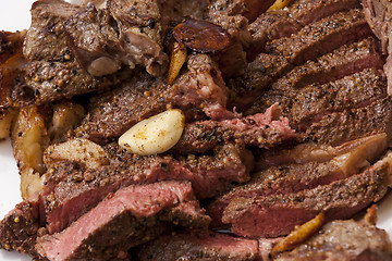 Image showing Plate of Grilled Steak and Garlic with Red Napkin