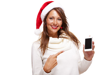 Image showing Pretty woman in a Santa hat reading an sms