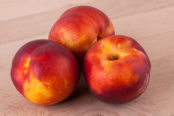 Image showing Three tasty fresh ripe juicy nectarines