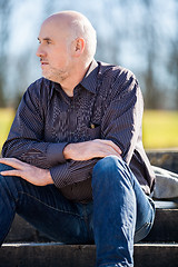 Image showing Thoughtful man sitting on a flight of steps