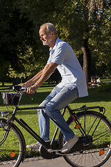 Image showing Senior Man Riding Bicycle