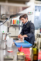 Image showing Chef cooking a vegetables stir fry over a hob