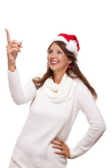 Image showing Young woman in a Santa hat holding out her hands