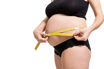 Image showing Pregnant woman measuring her abdomen