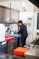 Image showing Chef cooking a vegetables stir fry over a hob