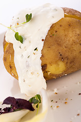 Image showing Baked jacket potato with sour cream sauce